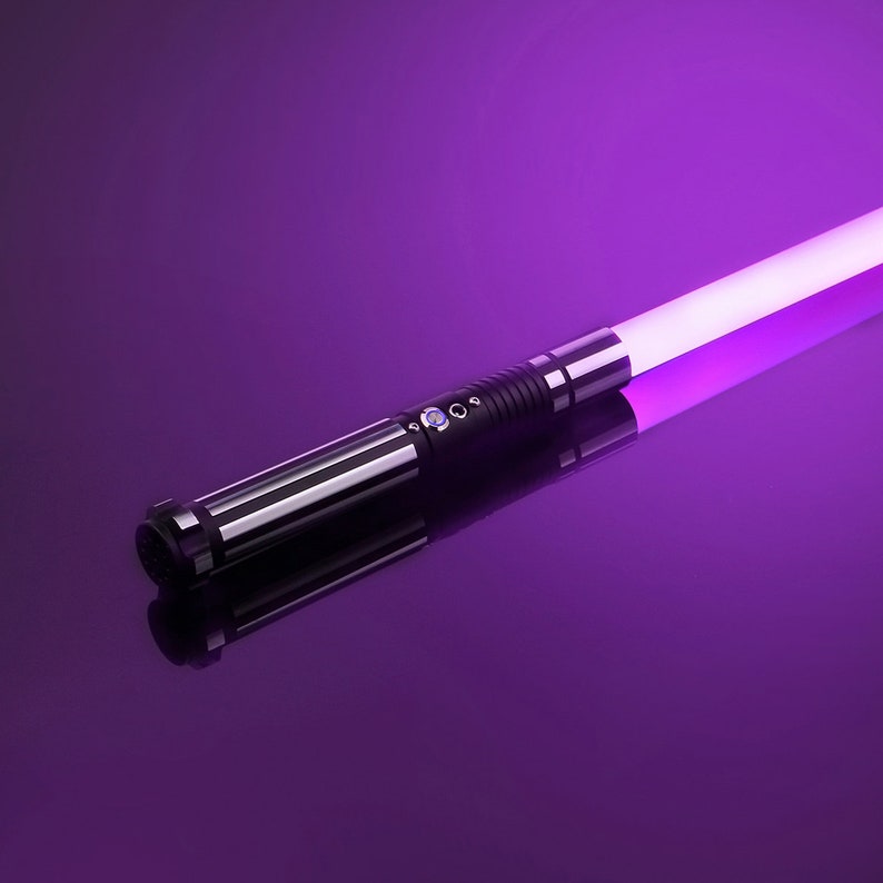 May include: A black lightsaber with a purple blade. The lightsaber is lying on a purple surface.