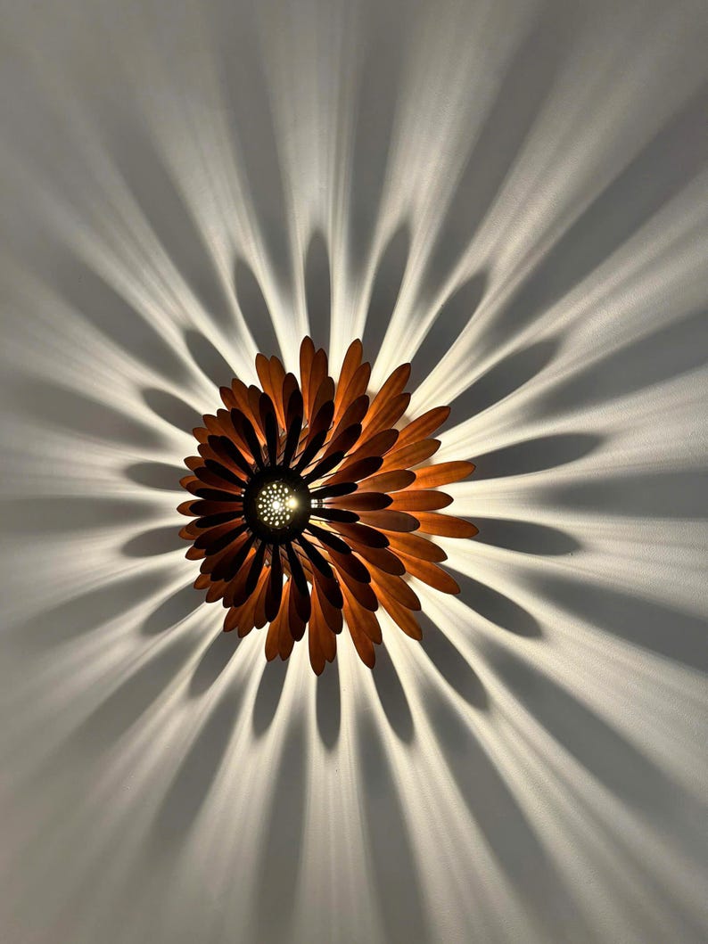 May include: A wooden ceiling light fixture shaped like a flower with brown petals and a central light source.