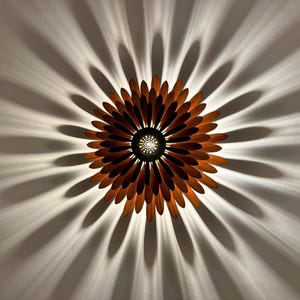 May include: A wooden ceiling light fixture shaped like a flower with brown petals and a central light source.