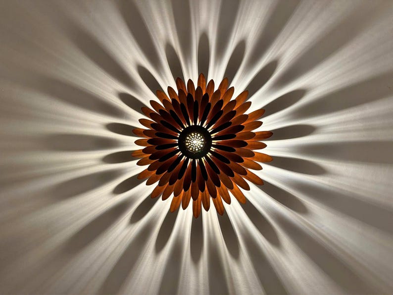 May include: A wooden ceiling light fixture shaped like a flower with brown petals and a central light source.