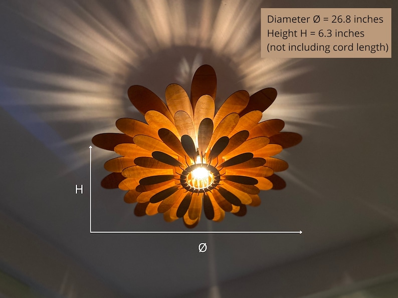 May include: A wooden ceiling light fixture shaped like a flower with multiple layers of petals. The light is on and the petals are illuminated. The fixture is 26.8 inches in diameter and 6.3 inches tall.