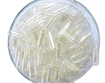 May include: A clear glass bowl filled with empty, clear gelatin capsules. The capsules are used for holding supplements or medications.