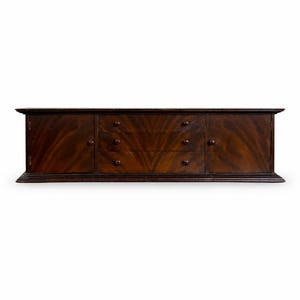 May include: A dark brown wooden sideboard. It features two doors and three drawers, with visible wood grain. The sideboard is rectangular and has dark brown hardware. The unit is approximately 180 cm in length.