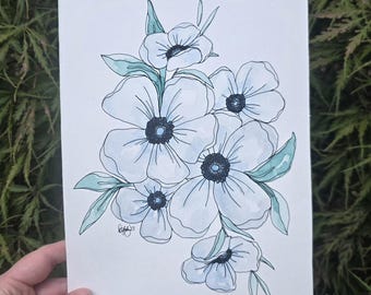 May include: A rectangular white paper featuring a hand-drawn illustration of five light blue flowers with dark centers and green leaves. The artwork uses black ink outlines and soft blue watercolor washes. A small signature and the year 23 are visible.