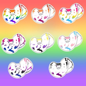 May include: Seven colorful snake stickers with a white background. The snakes are curled up in a heart shape and have a rainbow pattern.