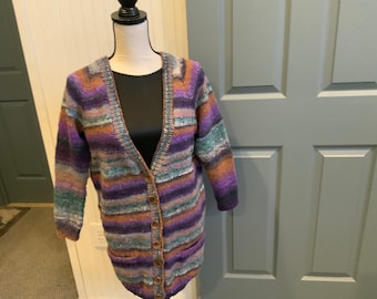 Size medium cardigan Hand knit in stockinette stitch. Noro kureopatora yarn. Warm and cozy.