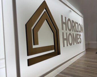 May include: A white sign with a gold geometric house logo and the text "HORIZON HOMES" in white lettering.