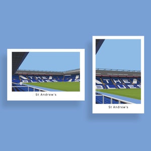 May include: Two illustrations of St. Andrew's Stadium, home of Birmingham City Football Club. The stadium is shown from different angles, with the words "The Blues" visible on the stands.