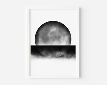 May include: Framed abstract art print with a black and grey design. The artwork shows a large, textured circle above a horizontal black line, with a semi-circle below. The background is white, and the print is in a white frame.