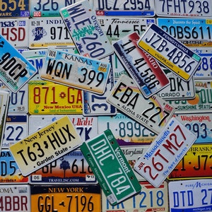 May include: A collection of vintage license plates from different states in the United States. The plates are in various colors and feature different designs, including state names, slogans, and numbers.