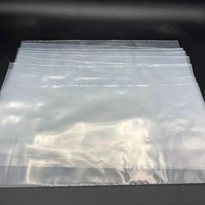 May include: A stack of clear plastic bags, likely for packaging or storage.