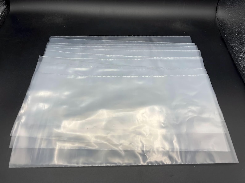 May include: A stack of clear plastic bags, likely for packaging or storage.