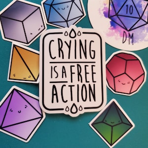 May include: A set of nine colorful stickers featuring cartoon dice with faces. The stickers are on a teal background. One sticker says "Crying is a free action". Another sticker says "World's Okay DM".