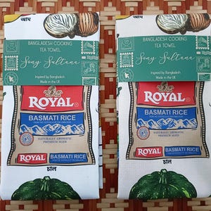 May include: Two tea towels with a white background, featuring a design of onions, green squash, and text. The towels are labeled "Bangladesh Cooking Tea Towel" and "Royal Basmati Rice". The text "Sony Sultana" is also visible.