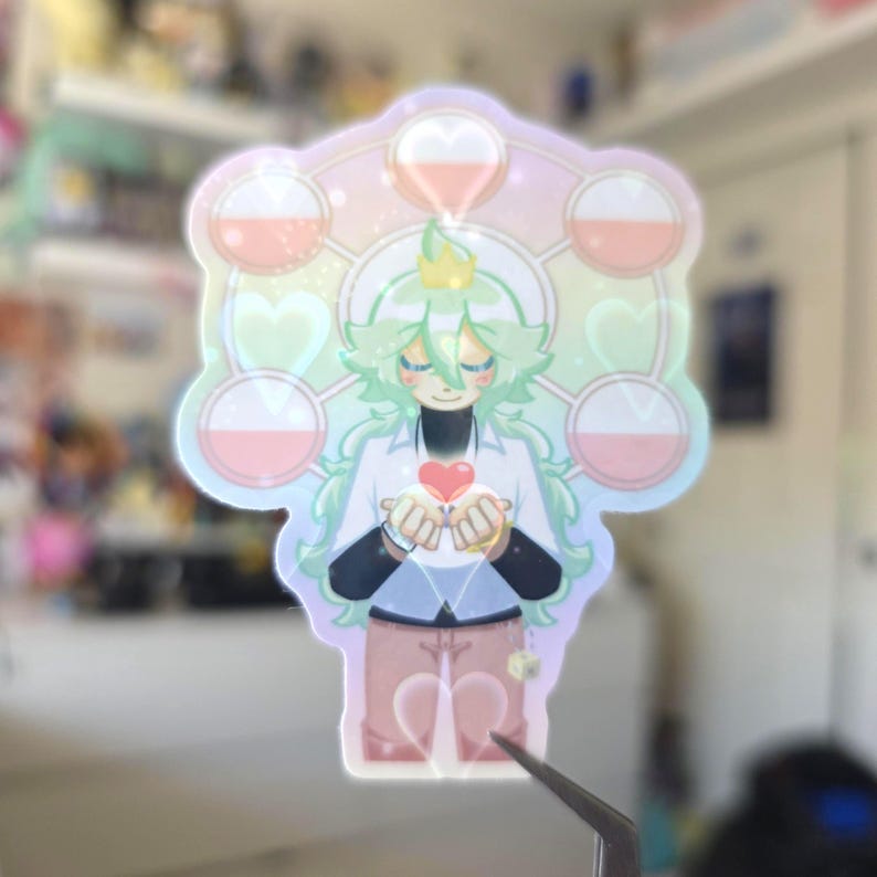 May include: A holographic sticker featuring an anime-style character with green hair and a crown, holding a red heart. The design includes pink and white orbs, hearts, and a pastel rainbow background.