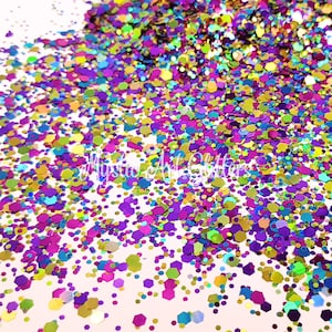 May include: A selection of iridescent glitter in a range of shapes and sizes, including round, hexagonal, and star-shaped glitter. The glitter is a mix of colours, including pink, purple, blue, green, gold, and silver.