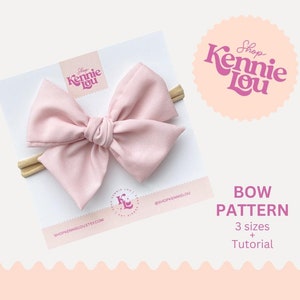 May include: A light pink fabric bow on a headband, displayed on a white card. The card has the text "Shop Kennie Lou" and "Bow Pattern" with "3 sizes + Tutorial". A pink logo is in the upper right corner.