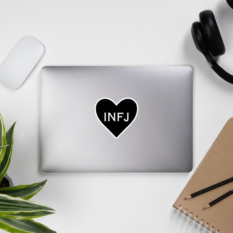 May include: Black and white sticker with a heart shape and the text "INFJ" inside.