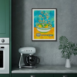 May include: A framed illustration of a bowl of pasta with a yellow background and a blue and green patterned bowl. The pasta is flying out of the bowl and there is a pasta server on the table.