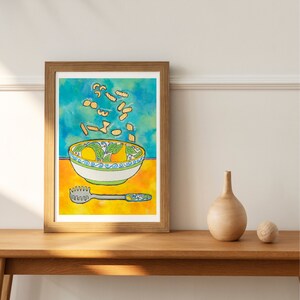 May include: A watercolour painting of a bowl of pasta with a blue and green pattern. The pasta is yellow and is flying out of the bowl. There is a yellow background and a silver pasta server on the table.
