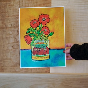 Pode incluir: Uma pintura de uma lata de tomates pelados Cento San Marzano com um buqu&ecirc; de papoulas vermelhas na frente. A lata est&aacute; sobre uma superf&iacute;cie azul com um fundo amarelo.