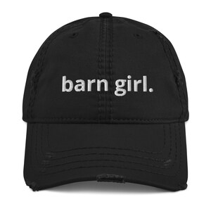 May include: Black distressed baseball cap with the embroidered text "barn girl." The cap has a curved brim and a worn, vintage look.
