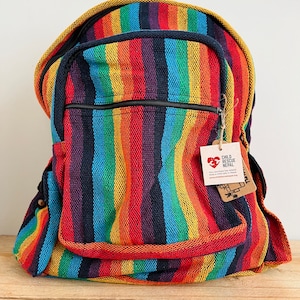 May include: Rainbow striped backpack with a black zipper and a small tag that says "Child Rescue Nepal".