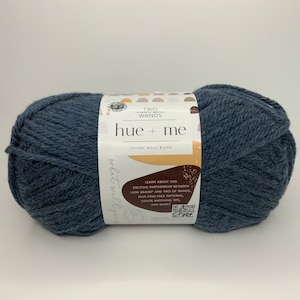 May include: A skein of blue chunky wool yarn labeled "hue + me" with the text "Two Wands Chunky Wool Blend" and a description of a partnership between Lion Brand and Two of Wands.
