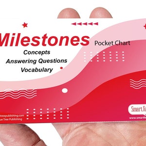 May include: A red and pink pocket chart with the text "Milestones Pocket Chart" and the words "Concepts, Answering Questions, Vocabulary". The chart has a white star in the top right corner and a white wave design in the bottom right corner. The chart is made by Smart Felt Toys.