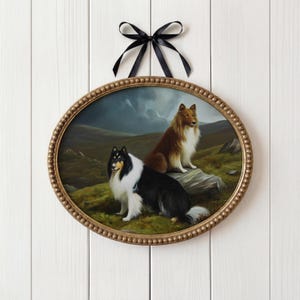 May include: Oval framed artwork depicting two collies in a landscape. One collie is black and white, the other is brown and white. The frame is gold with a beaded edge, and a black ribbon is attached for hanging.