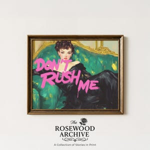 May include: A framed print featuring a vintage illustration of a woman in a black dress reclining on a green sofa. The words "DON'T RUSH ME" are written in bright pink across the image. The Rosewood Archive logo is at the bottom.