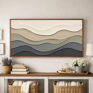 May include: A rectangular wall art piece featuring horizontal, layered wave patterns in a palette of cream, beige, sage green, and dark charcoal grey. The artwork has a thick, textured impasto finish and is enclosed in a thin wooden frame.