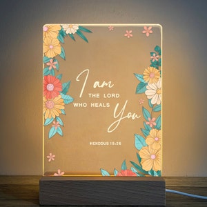 May include: A light-up sign with a floral design and the text "I am the Lord who heals you" and the scripture reference "Exodus 15:26".