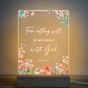May include: A white light-up sign with a floral border and the text "For nothing will be impossible with God - Luke 1:37".