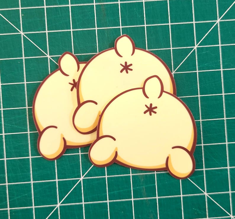May include: Three yellow cartoon character stickers with brown outlines. Each sticker has a small tail and a star on its back.