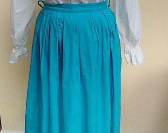 May include: A turquoise pleated skirt with a white button-up shirt. The skirt has a high waist and is knee-length.