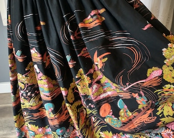 May include: A black full skirt with a colorful floral print featuring stylized figures and boats. The print is in shades of orange, pink, green, and blue.