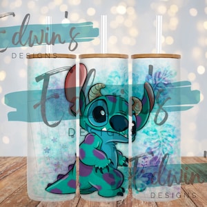 May include: A white tumbler with a blue and purple watercolor background featuring a cartoon Stitch character. The tumbler has a bamboo lid and a straw.