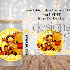 May include: A clear 16oz Libbey glass can with a bamboo lid and straw. The glass features a yellow Starbucks-themed design with Winnie the Pooh and Tigger hugging. The design includes the text "STARBUCKS COFFEE".