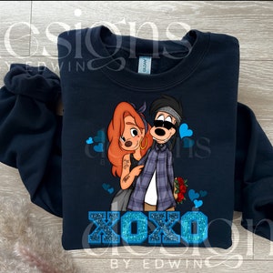 May include: A navy blue sweatshirt with a cartoon image of a couple. The woman has red hair and is wearing a blue dress. The man is wearing a plaid shirt and a bandana. The text "XOXO" is printed in blue glitter on the front of the sweatshirt.
