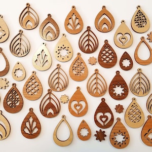 May include: Assortment of wooden earrings in various shapes and designs, including geometric, floral, and abstract patterns. The earrings are made of light brown wood and have a natural finish.
