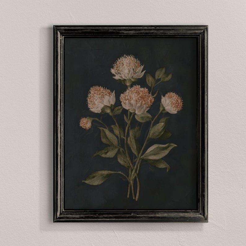 May include: A framed floral print featuring a bouquet of light pink flowers with green leaves against a dark blue background. The flowers have a textured appearance, and the frame is black.