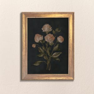 May include: A framed botanical print featuring a cluster of flowers with light peach-colored blooms and green leaves against a dark navy background. The artwork is enclosed in a gold-colored frame, creating a vintage aesthetic.