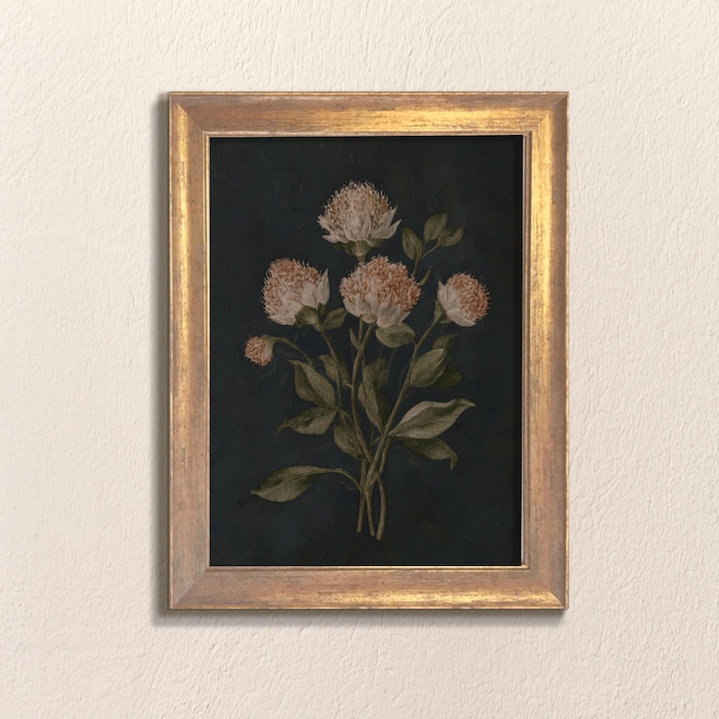 May include: A framed botanical print featuring a cluster of flowers with light peach-colored blooms and green leaves against a dark navy background. The artwork is enclosed in a gold-colored frame, creating a vintage aesthetic.