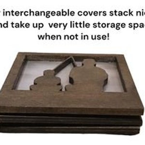 May include: Stackable brown wooden interchangeable covers with a cutout design of a person fishing. The covers have a rectangular shape and the text "Our interchangeable covers stack nicely and take up very little storage space when not in use!"