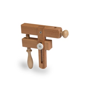 Securely hold cross stitch frames,  embroidery frames, and stitching hoops with our wooden table clamp. Essential stitching tool.