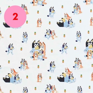 May include: A white background with a repeating pattern of blue, orange, and red cartoon dogs. The dogs are in various poses, including standing, sitting, and running. The number "2" is in a pink circle in the upper left corner of the image.