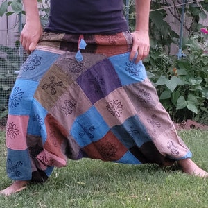 May include: Patchwork pants with a variety of colors and patterns, including blue, brown, and green. The pants have a loose, flowing fit and are made of a soft, comfortable fabric.