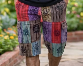 May include: Multi-colored cargo shorts featuring a patchwork design of vertical stripes in red, purple, brown, and teal. The shorts are decorated with black printed floral and circular symbols, include side cargo pockets, and have a drawstring waist.