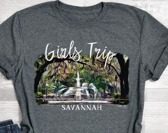May include: Gray t-shirt with a graphic of a fountain in Savannah, Georgia. The text "Girls Trip Savannah" is printed on the shirt.